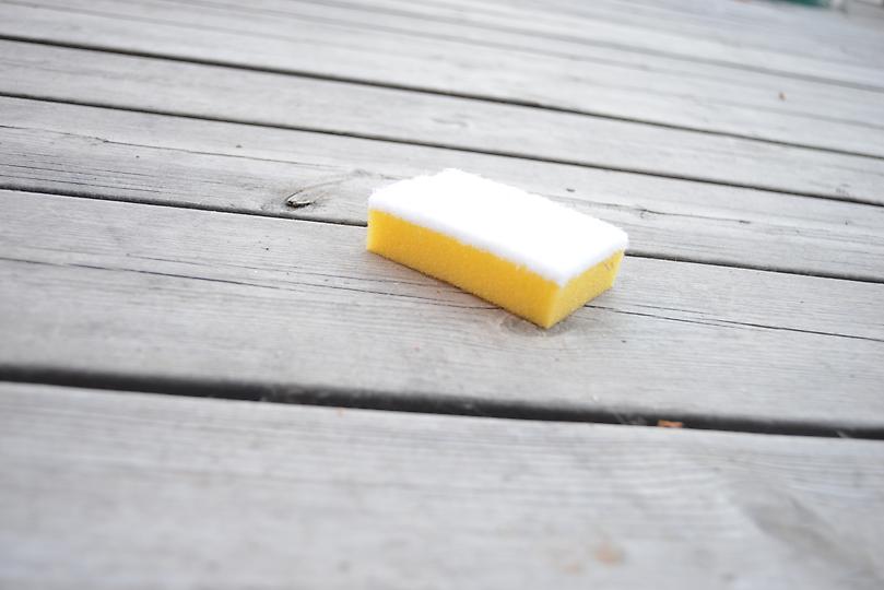Picture on a bath sponge drowned in cleaners for decking and façades.